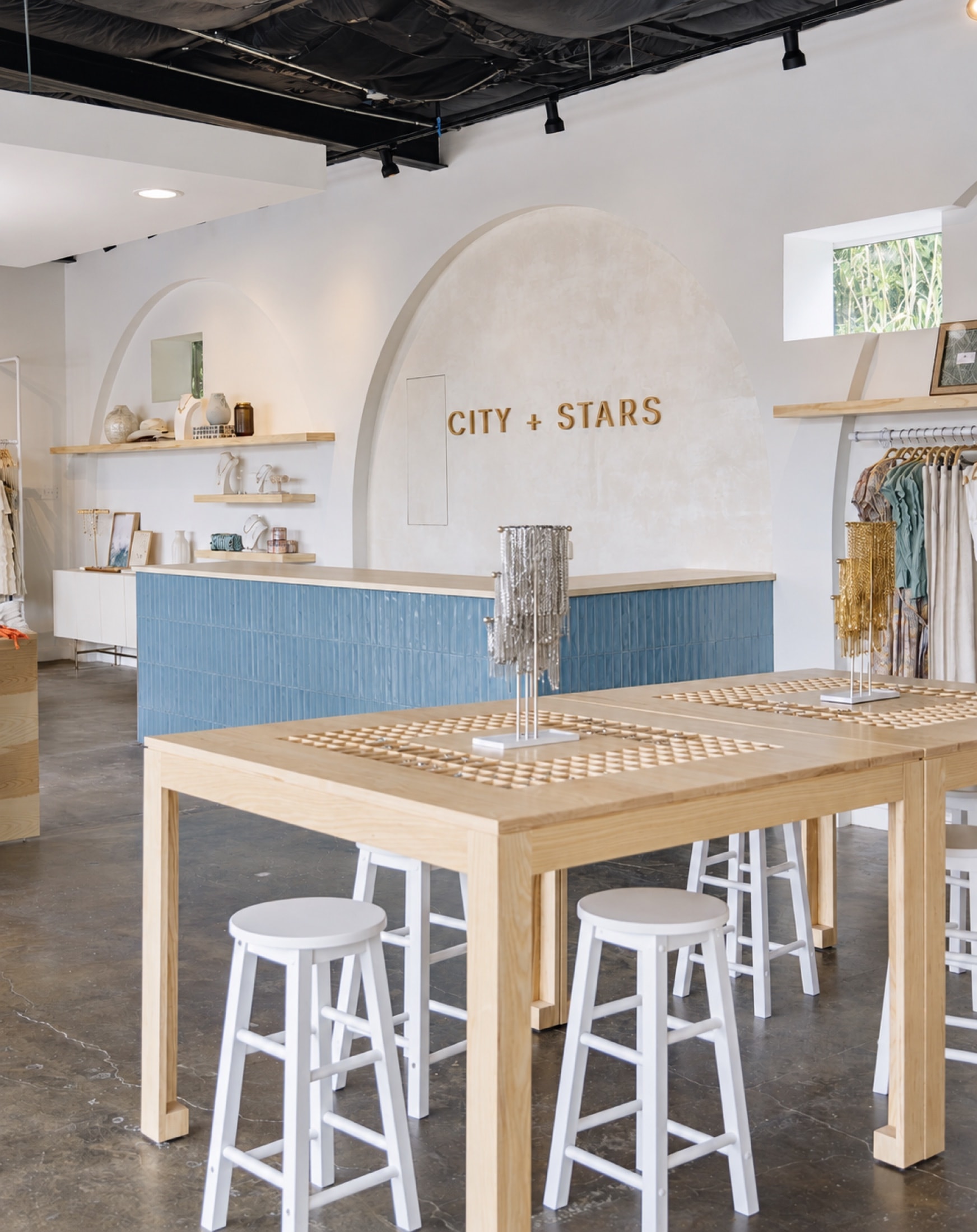 Custom charm tables with routed tray surfaces in City + Stars Austin boutique