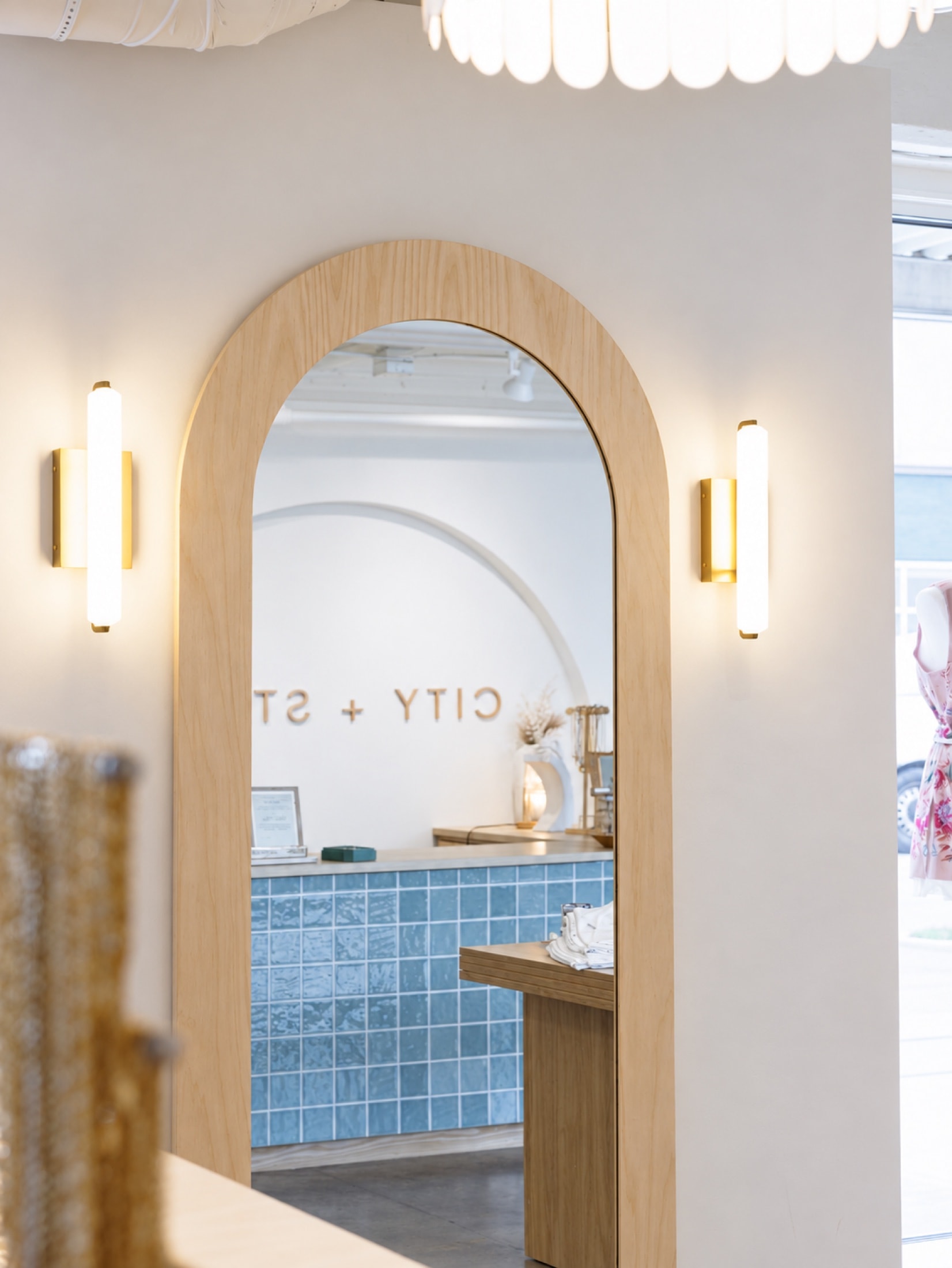 Arched wood-framed mirror in City + Stars Midtown Oklahoma City boutique